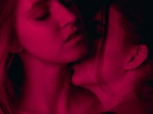 two woman wearing brassieres