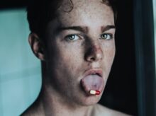 topless man with red tongue out