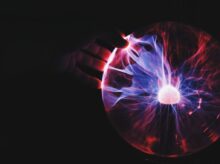 human hand holding plasma ball