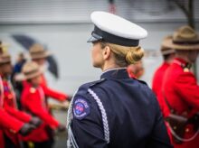 focus photo of woman in black top wearing white and black hat