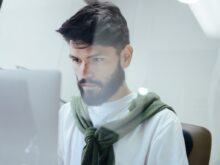 man facing MacBook Pro