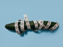 green cucumber and measuring tape