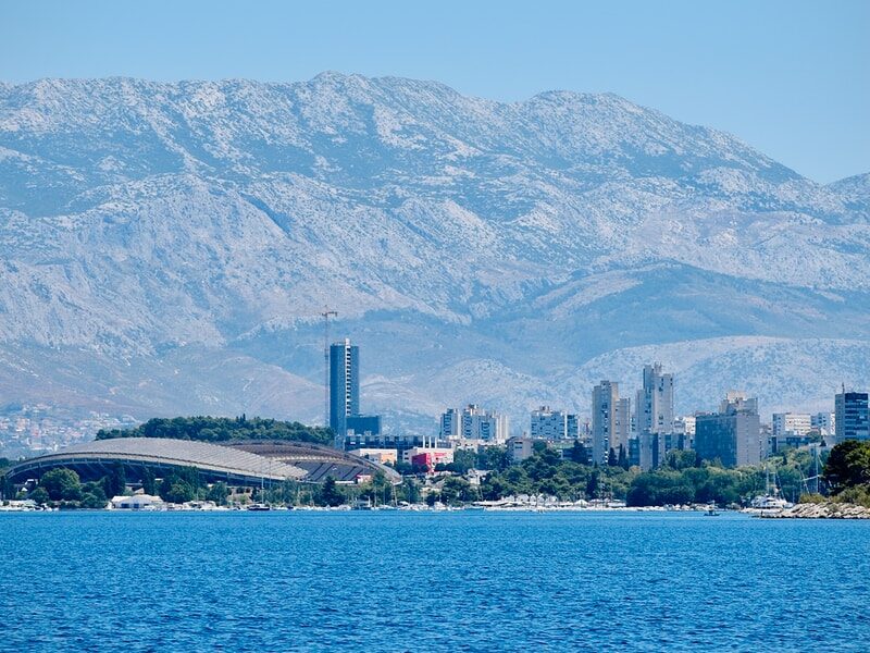 body of water near mountain during daytime
