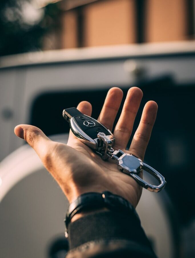 person holding Mercedes-Benz fob
