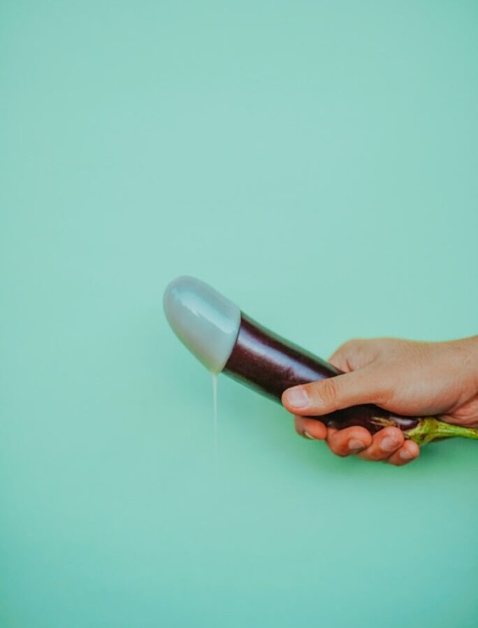 person holding black and pink plastic bottle