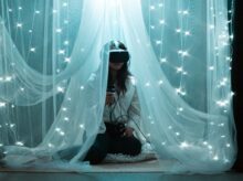 woman in black and white dress sitting on bed