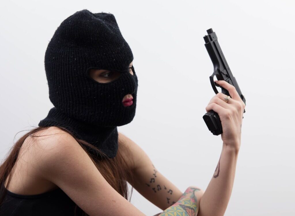 woman with bonnet and semi automatic handgun
