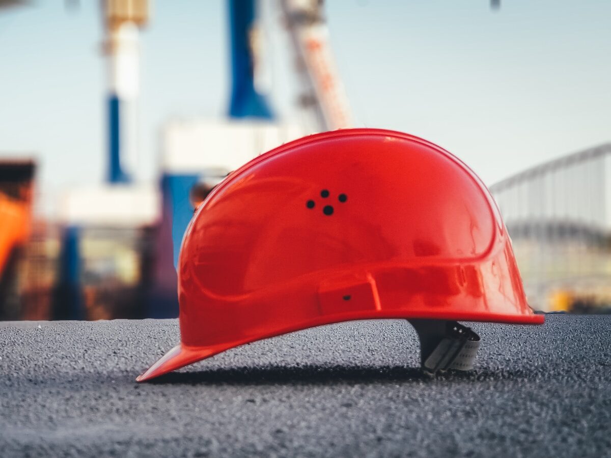 red hard hat on pavement